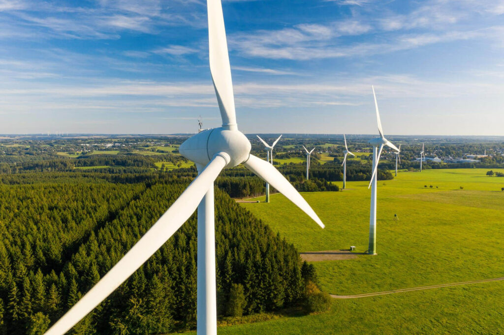 Turbinas eólicas y generación de energía renovable: varios molinos de viento en un campo verde